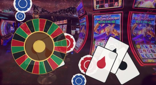 Roulette wheel with playing cards and poker chips in a casino arcade.