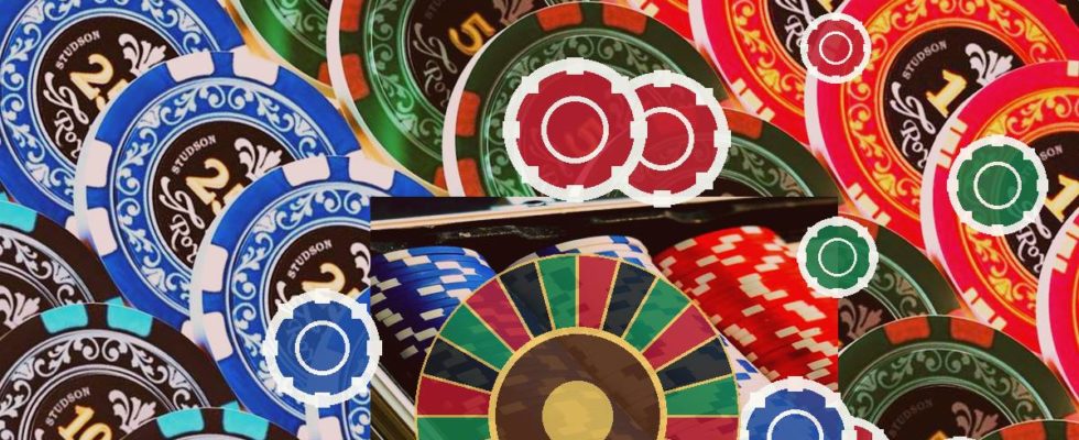 Colorful casino chips scattered over a roulette wheel, suggesting gambling and betting.